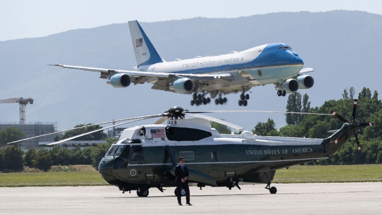 Air Force One carrying US President Donald Trump lands at the Geneva Airport with Marine One helicopter in the foreground ahead of the G7 summit