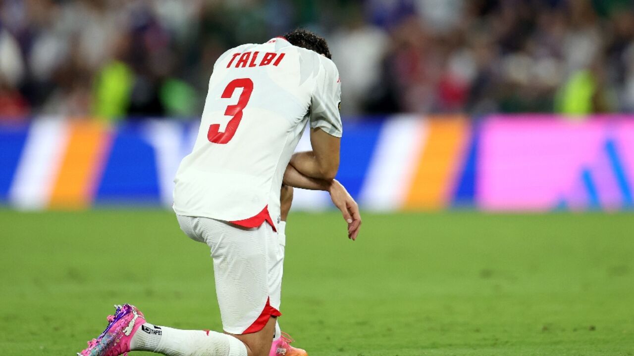 Tunisia's dejected players have already been knocked out of the World Cup after conceding nine goals in two matches