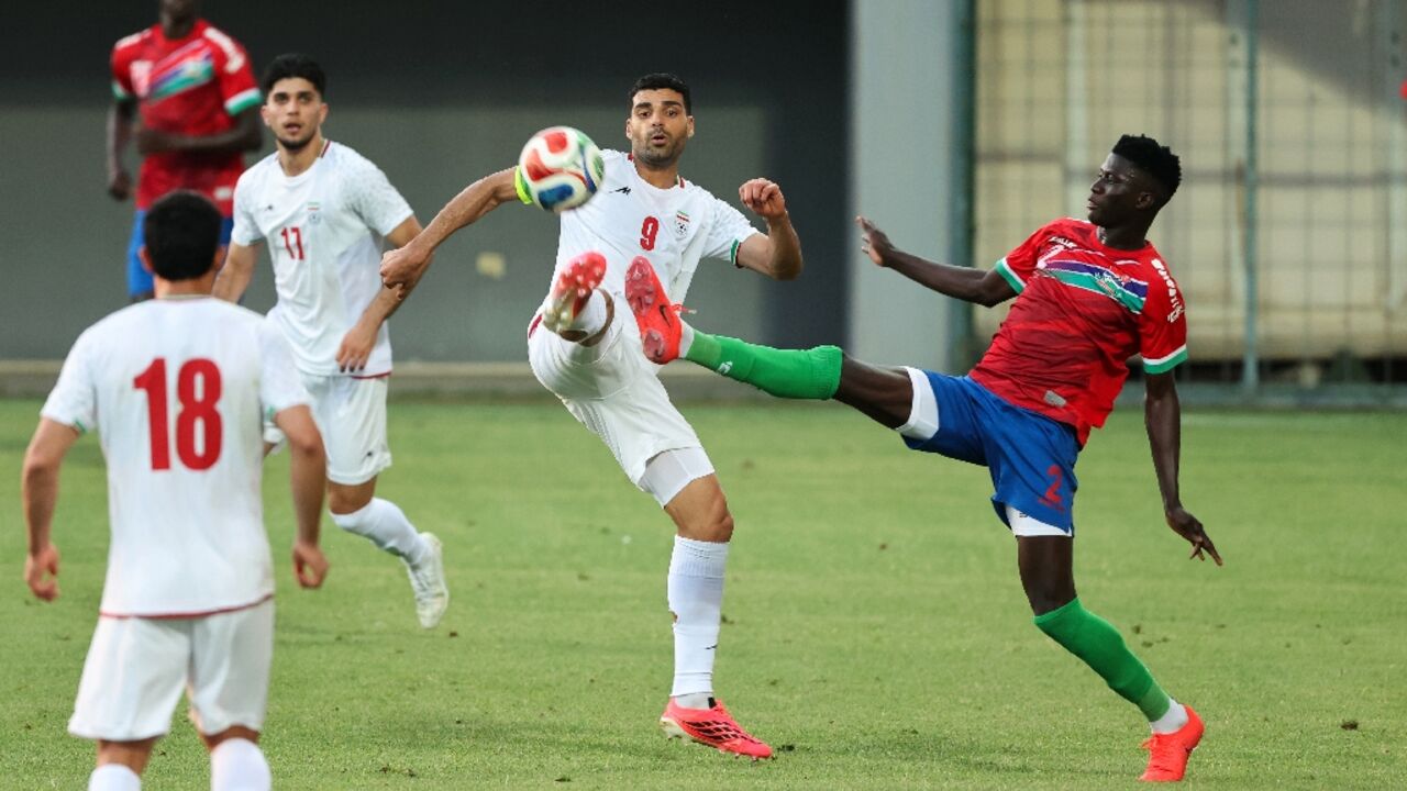 Iran's Mehdi Taremi fights for the ball with Gambia's Mahmudu Bajo during a friendly between the two teams in Antalya on May 29 