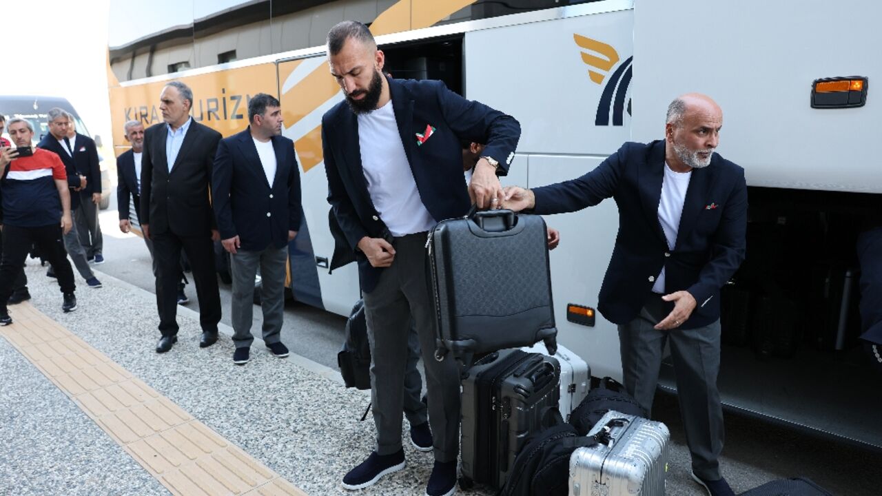 Iranain midfielder Roozbeh Cheshmi gets off a bus as Iran's World Cup squad arrives at Antalya airport for their flight to Mexico ahead of the tournament