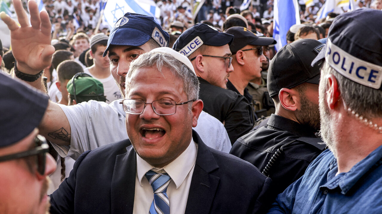 Israeli policemen surround Israeli Minister of National Security and far-right politician Itamar Ben-Gvir as he arrives outside the Damascus Gate of the walled Old City of Jerusalem on May 26, 2025, during a flag march for Jerusalem Day, commemorating the Israeli army's 1967 capture of the city's eastern sector during the Arab-Israeli war. 