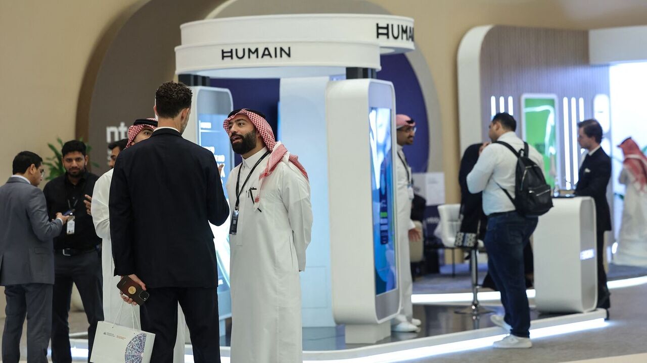 Guests stand at the booth of Saudi artificial intelligence company Humain during the Future Investment Initiative conference in Riyadh on Oct. 29, 2025. — FAYEZ NURELDINE/AFP via Getty Images