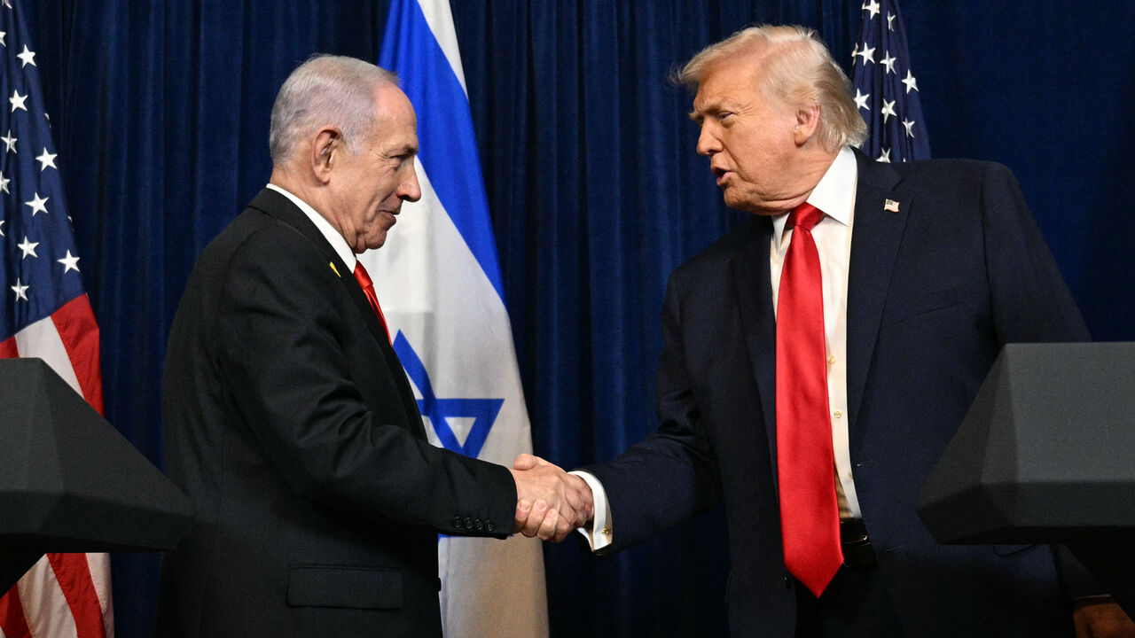 US President Donald Trump (R) and Israeli Prime Minister Benjamin Netanyahu shake hands as they arrive to speak to journalists during a joint press conference at Trump's Mar-a-Lago residence in Palm Beach, Florida, on Dec. 29, 2025.  
