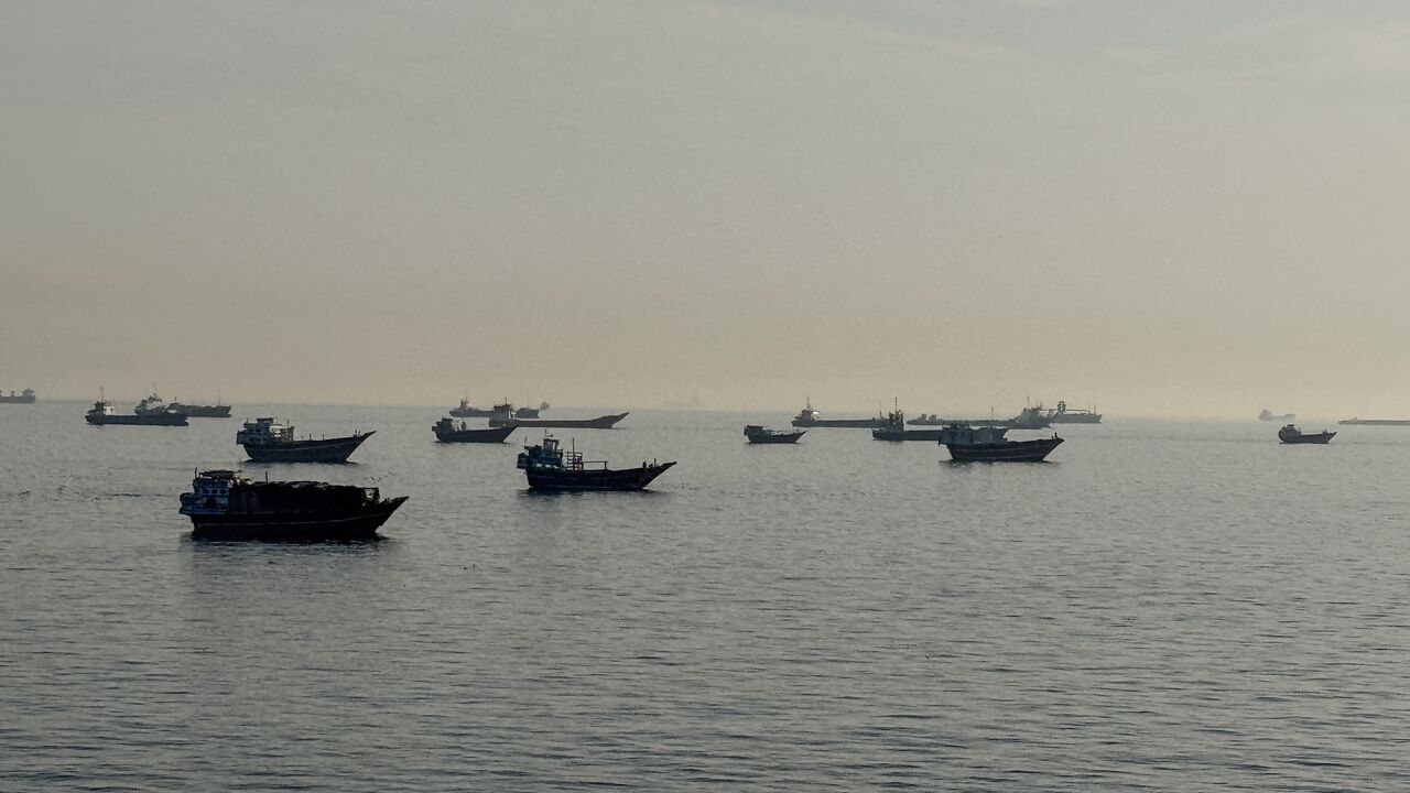 Vessels are seen anchored in the Strait of Hormuz, off the port city of Khasab on Oman's northern Musandam Peninsula, on May 17, 2026. 