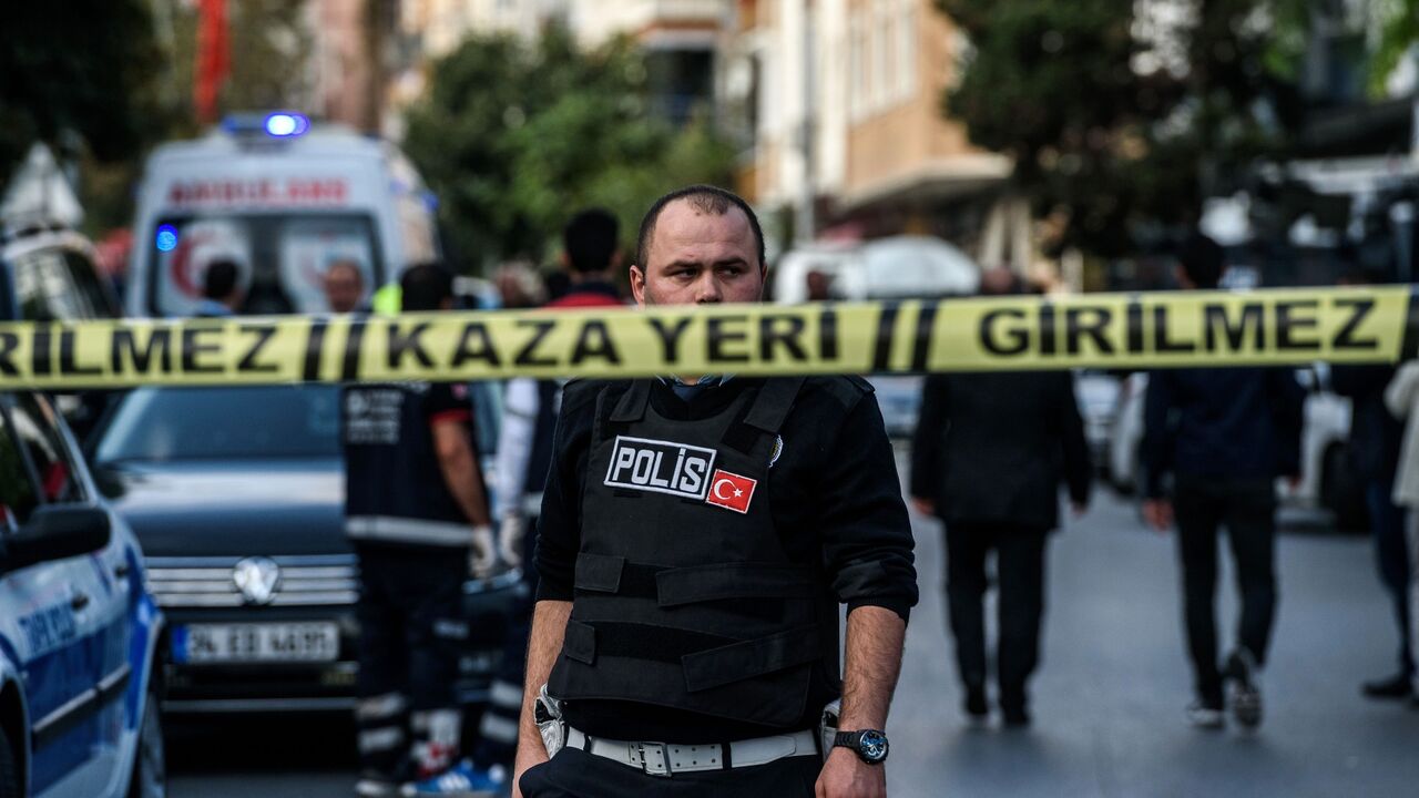 A Turkish police officers patrols at the scene of a motor-bike bomb explosion, next to a police station on Oct. 6, 2016, in Istanbul. 