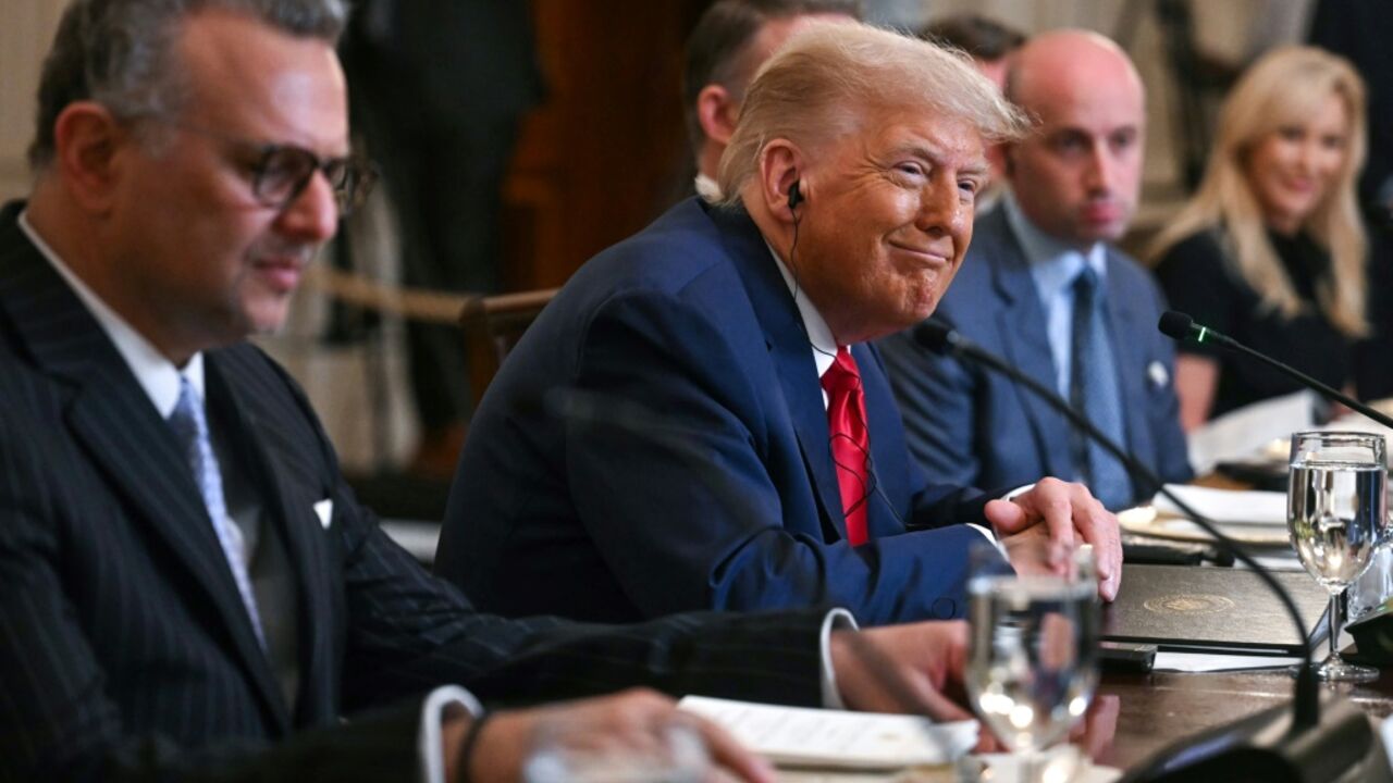 US President Donald Trump, flanked by US Senior Advisor for Africa Massad Boulo and White House Deputy Chief of Staff Stephen Miller, participates in a multilateral lunch with visiting African Leaders in the State Dining Room of the White House
