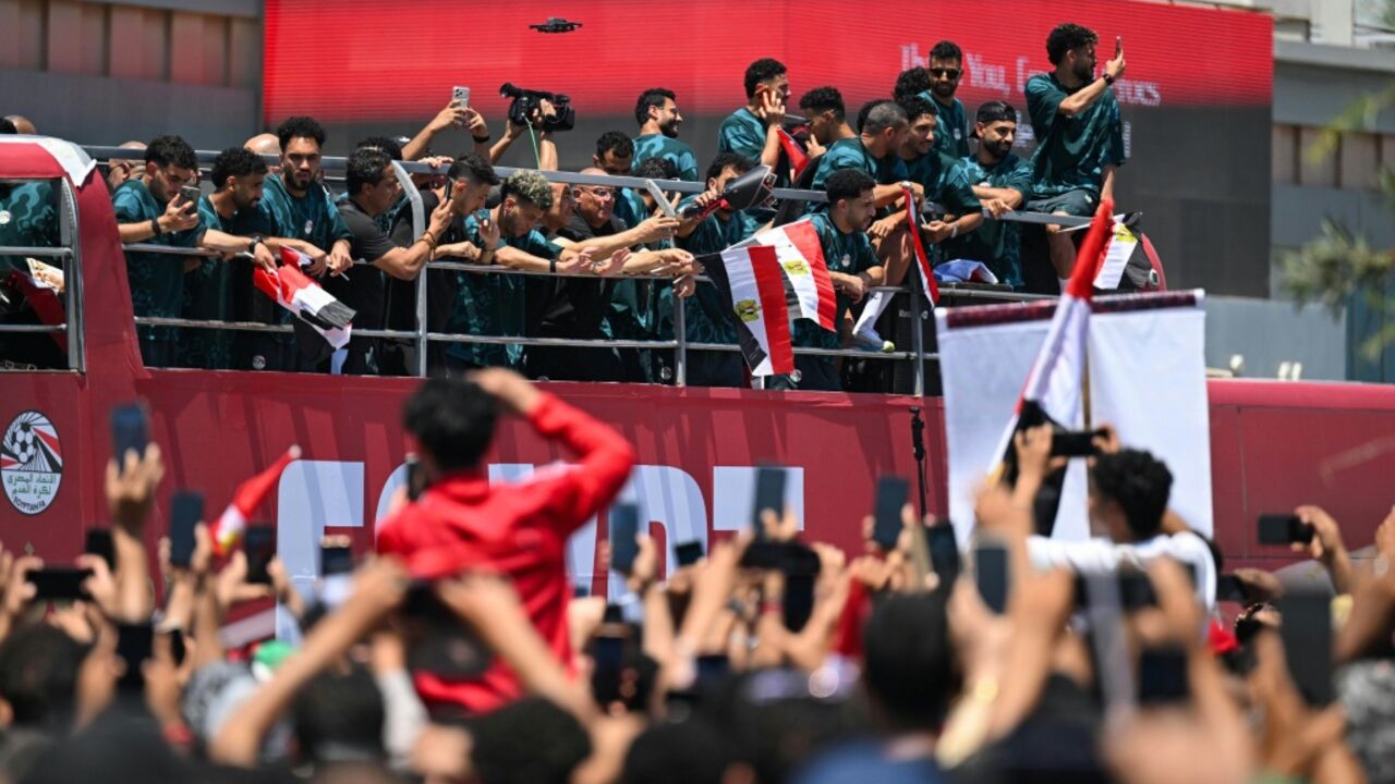 A sea of fans dressed in red, white and black filled the grounds outside the airport in El-Alamein, where the Pharaohs boarded an open-top bus for a parade through the coastal city