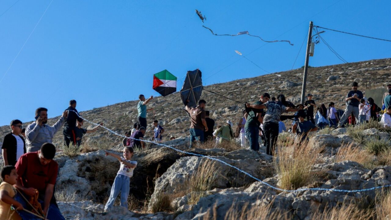 Palestinians from the Israeli-occupied WEst Bank village of Burin celebrate the annual kites festival, which they say offers some respite from the daily hardship
