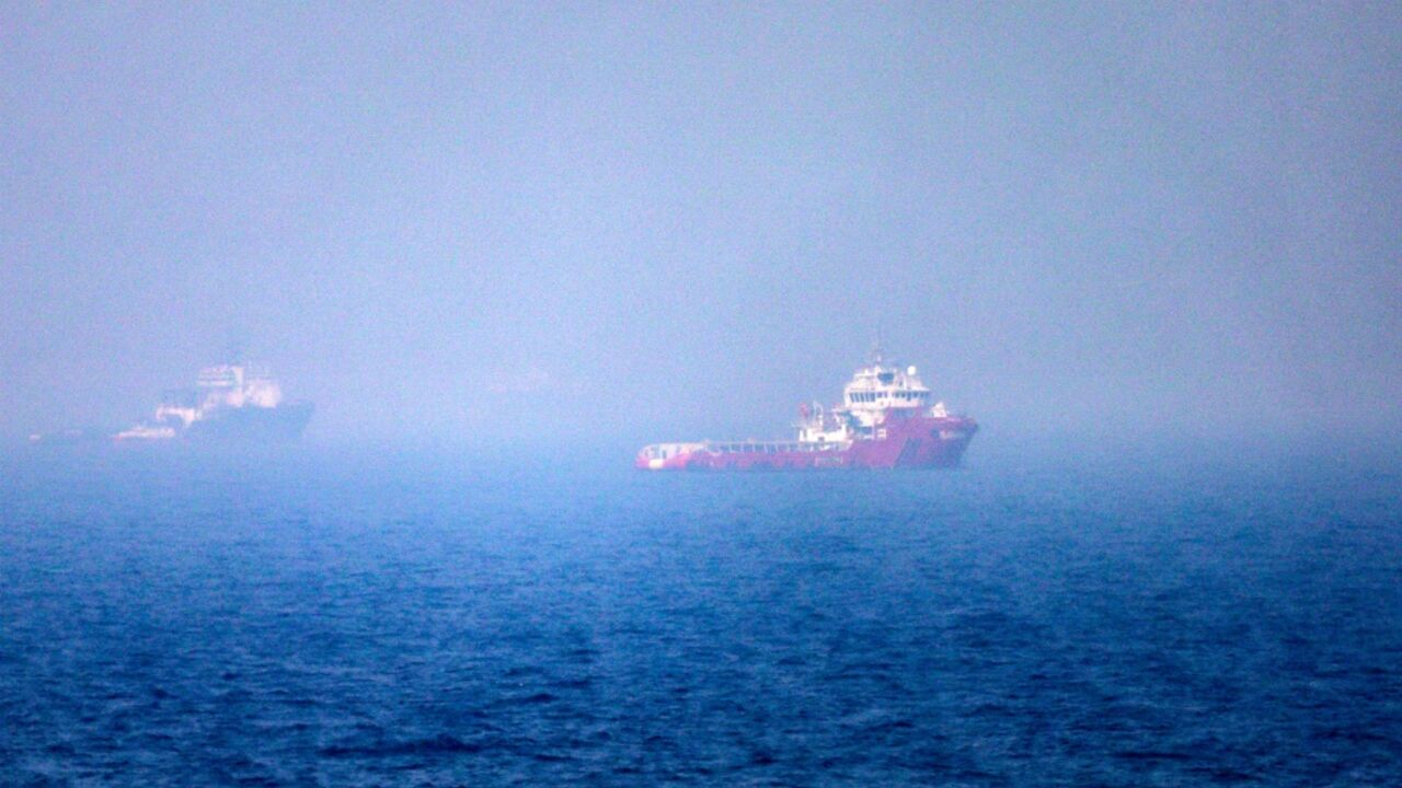 Ships sail near the Strait of Hormuz off the eastern coast of the United Arab Emirates on July 13, 2026