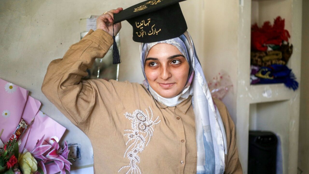 Palestinian student Saba Rabah celebrates with family at the Maghazi camp for Palestinian refugees in the central Gaza Strip