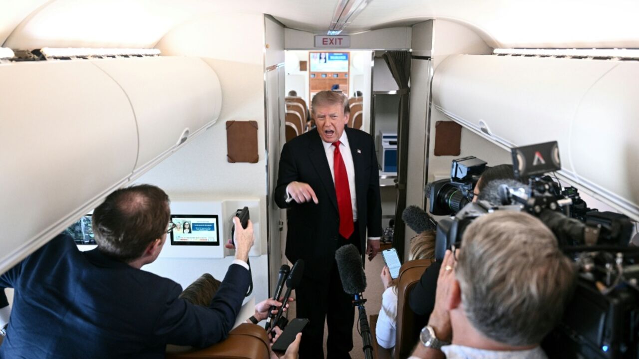 US President Donald Trump speaks to the press on board Air Force One, in the air en route to Michigan, on July 27, 2026