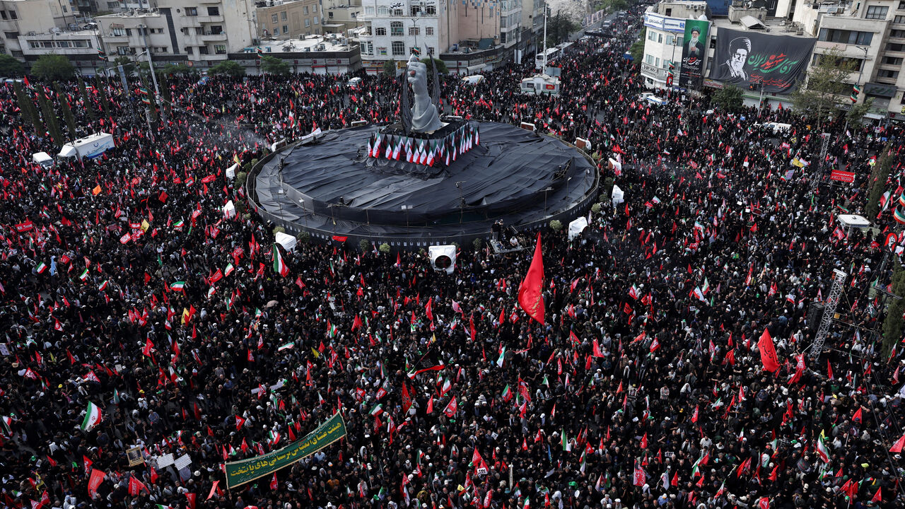 Mourners gather around a monument in the form of a raised fist of the deceased supreme leader of Iran, Ayatollah Ali Khamenei, in Enghelab Square, during a funeral procession for Khamenei, who was killed on February 28 in Israeli and U.S. airstrikes, in Tehran, Iran, July 6, 2026.  REUTERS/Murad Sezer