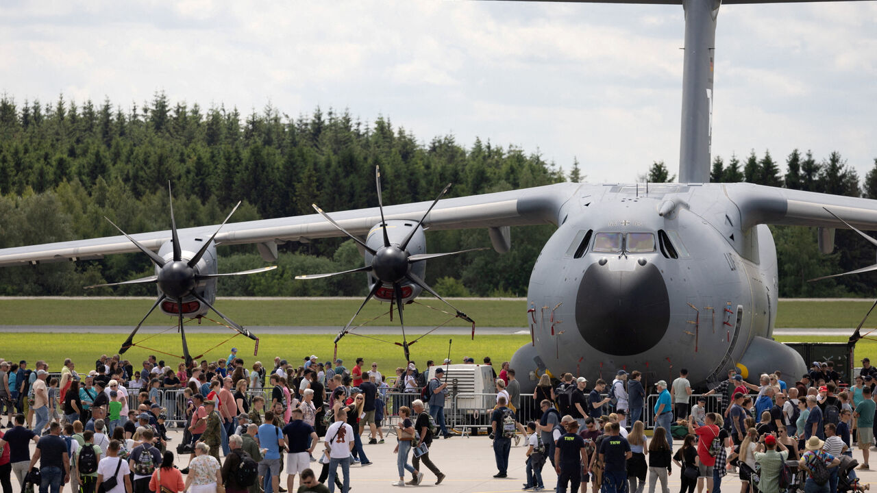 Visitors walk in front of a Airbus A400M during the "Tag der Bundeswehr", where the German armed forces Bundeswehr open their doors to the public, in Laage, northeastern Germany, June 6, 2026. REUTERS/Axel Schmidt