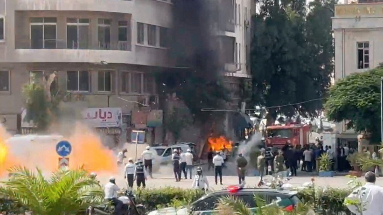 Emergency personnel work as smoke and fire rise at the site where explosive devices blew up near a hotel where French President Emmanuel Macron was meant to be staying, in Damascus, Syria, in this screengrab obtained from a video, July 7, 2026. REUTERS/Yamam Al Shaar