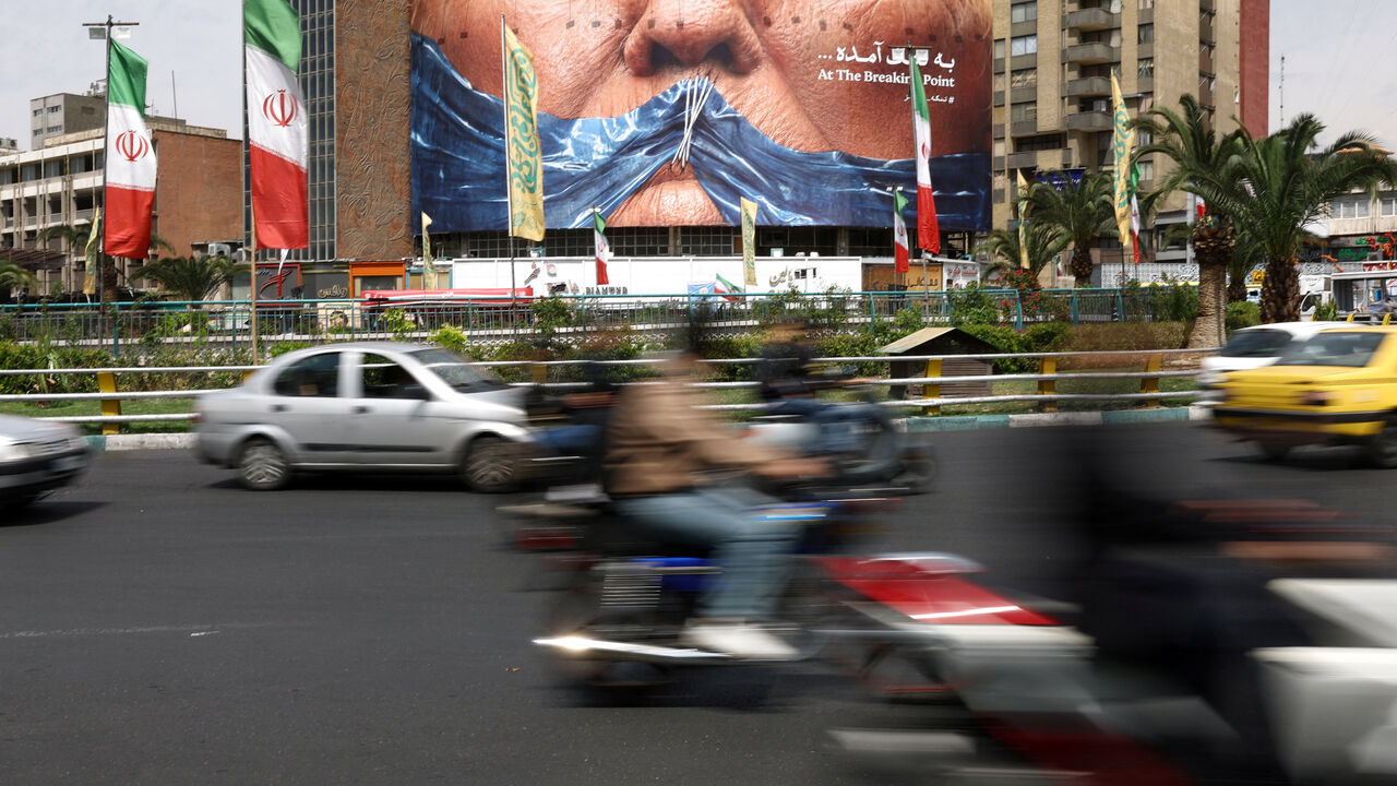 People drive past an anti-U.S. billboard depicting U.S. President Donald Trump and the Strait of Hormuz, in Tehran, Iran, May 2, 2026. Majid Asgaripour/WANA (West Asia News Agency) via REUTERS