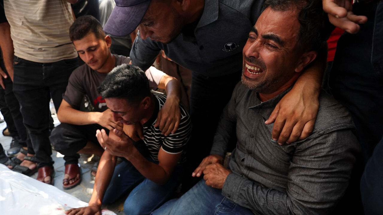 Mourners react during the funeral of six Palestinian police officers who were killed in an Israeli strike on a police station, according to medics, at Al Shifa Hospital in Gaza City, July 14, 2026. REUTERS/Dawoud Abu Alkas