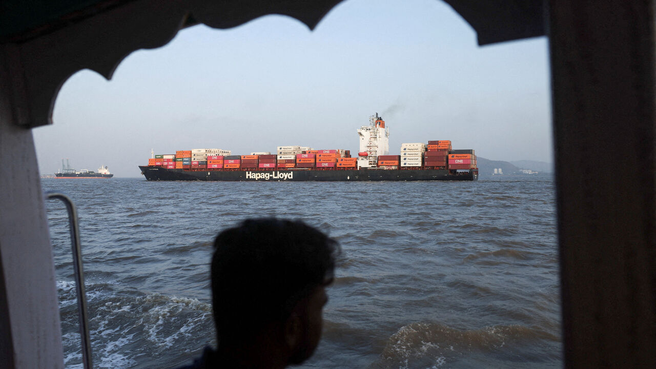 FILE PHOTO: A man looks at a container ship in the Arabian Sea off the coast of Mumbai, India, May 6, 2026. REUTERS/Francis Mascarenhas/File Photo