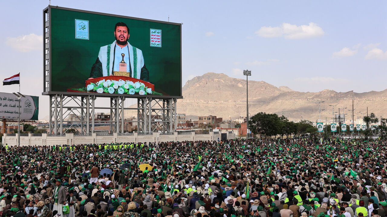 Abdul-Malik al-Houthi appears on a screen as people, mainly Houthi supporters, gather to mark the Prophet Muhammad's birthday, at Sabeen Square in central Sanaa, Yemen September 4, 2025. REUTERS/Khaled Abdullah