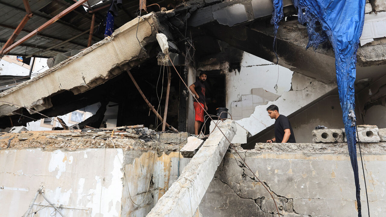 Palestinians inspect the site of an Israeli strike on a house in Gaza City, July 21, 2026. REUTERS/Dawoud Abu Alkas