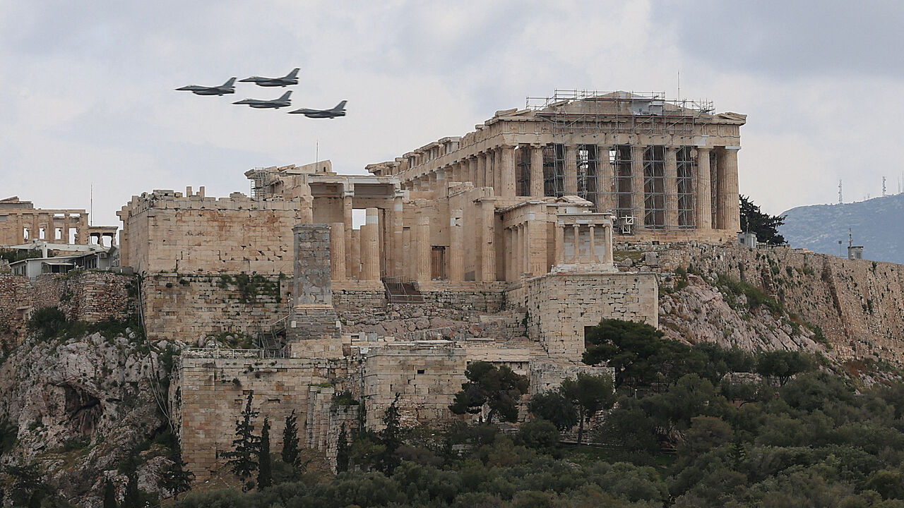 FILE PHOTO: Military planes fly above the Acropolis of Athens, as part of a military parade marking the country’s Independence Day, in Athens, Greece, March 25, 2026. REUTERS/Louisa Gouliamaki/File Photo