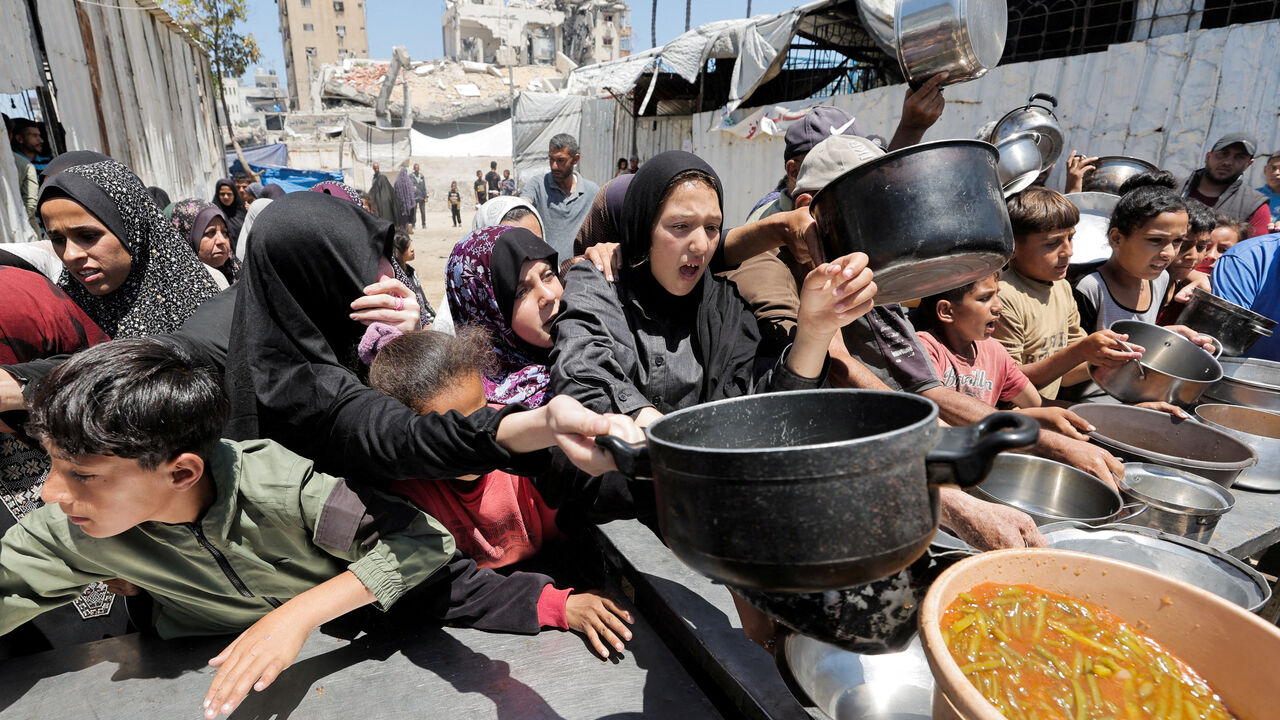 Palestinians gather to receive food from a charity kitchen, in Gaza City, June 2, 2026. REUTERS/Dawoud Abu Alkas