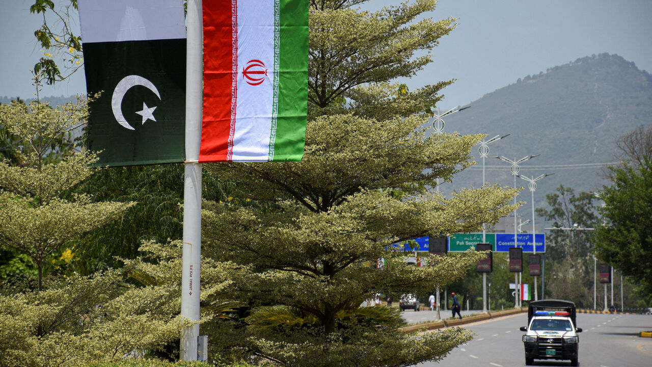 Iranian and Pakistani national flags are displayed along a street ahead of the arrival of Iran's President Masoud Pezeshkian in Islamabad, Pakistan, June 23, 2026. REUTERS/Waseem Khan