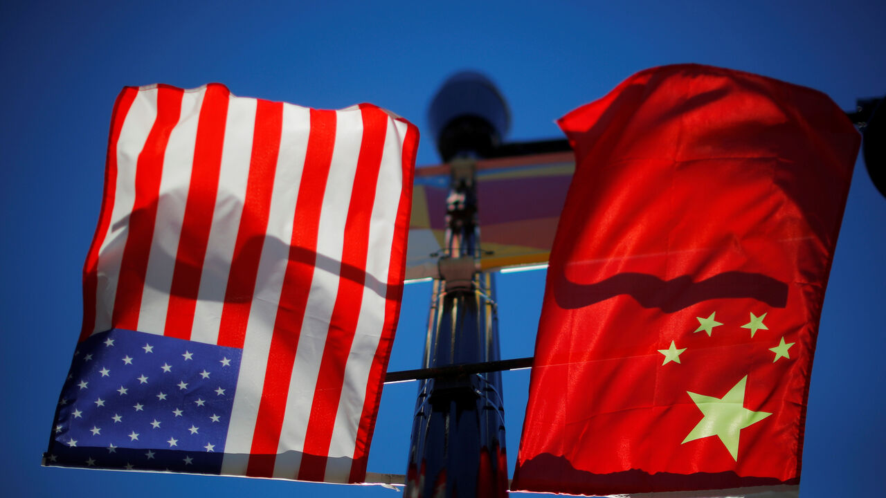 The flags of the United States and China fly from a lamppost in the Chinatown neighborhood of Boston, Massachusetts, U.S., November 1, 2021. REUTERS/Brian Snyder
