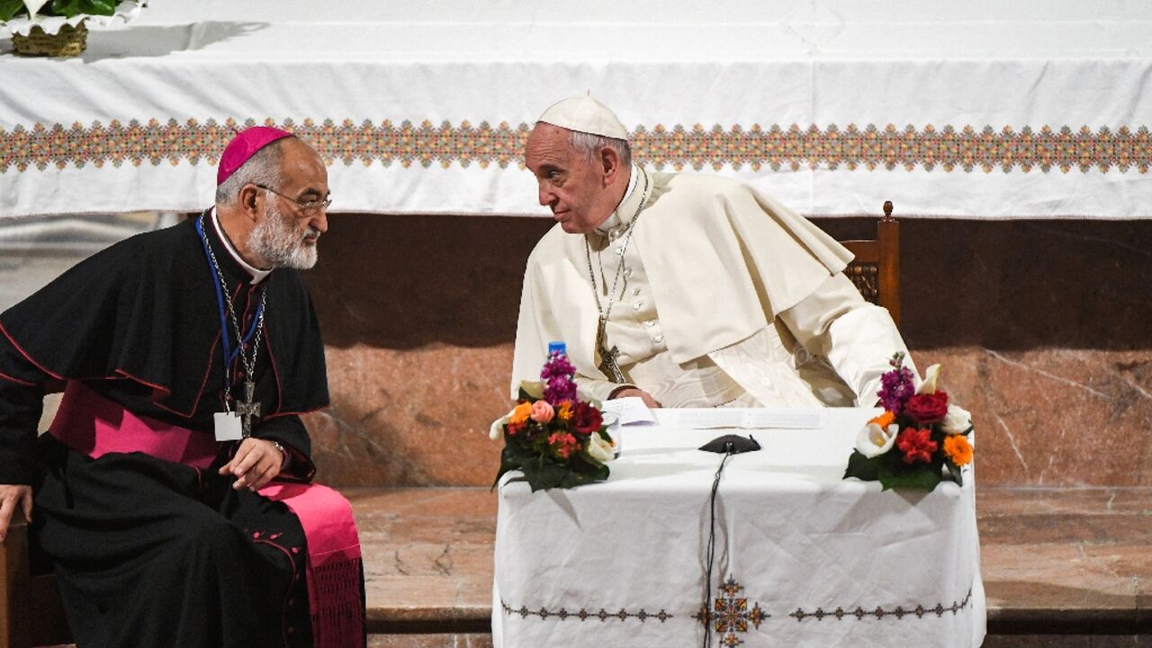 Pope Francis speaks with the Cardinal Cristobal Lopez Romero (left) during his papal visit to Morocco in 2019