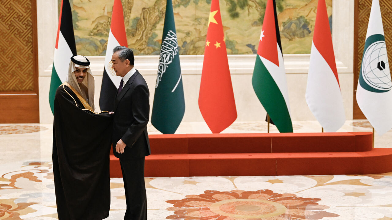 China's Foreign Minister Wang Yi (R) shakes hands with Saudi Arabia's Foreign Minister Prince Faisal bin Farhan Al-Saud before a family photo for the attendees of a meeting of foreign ministers from Arab and Muslim-majority nations at the Diaoyutai State Guest House in Beijing on November 20, 2023. The international community must take urgent action to stop the "humanitarian disaster" unfolding in Gaza, Chinese Foreign Minister Wang Yi told visiting diplomats from Arab and Muslim-majority nations on Novembe