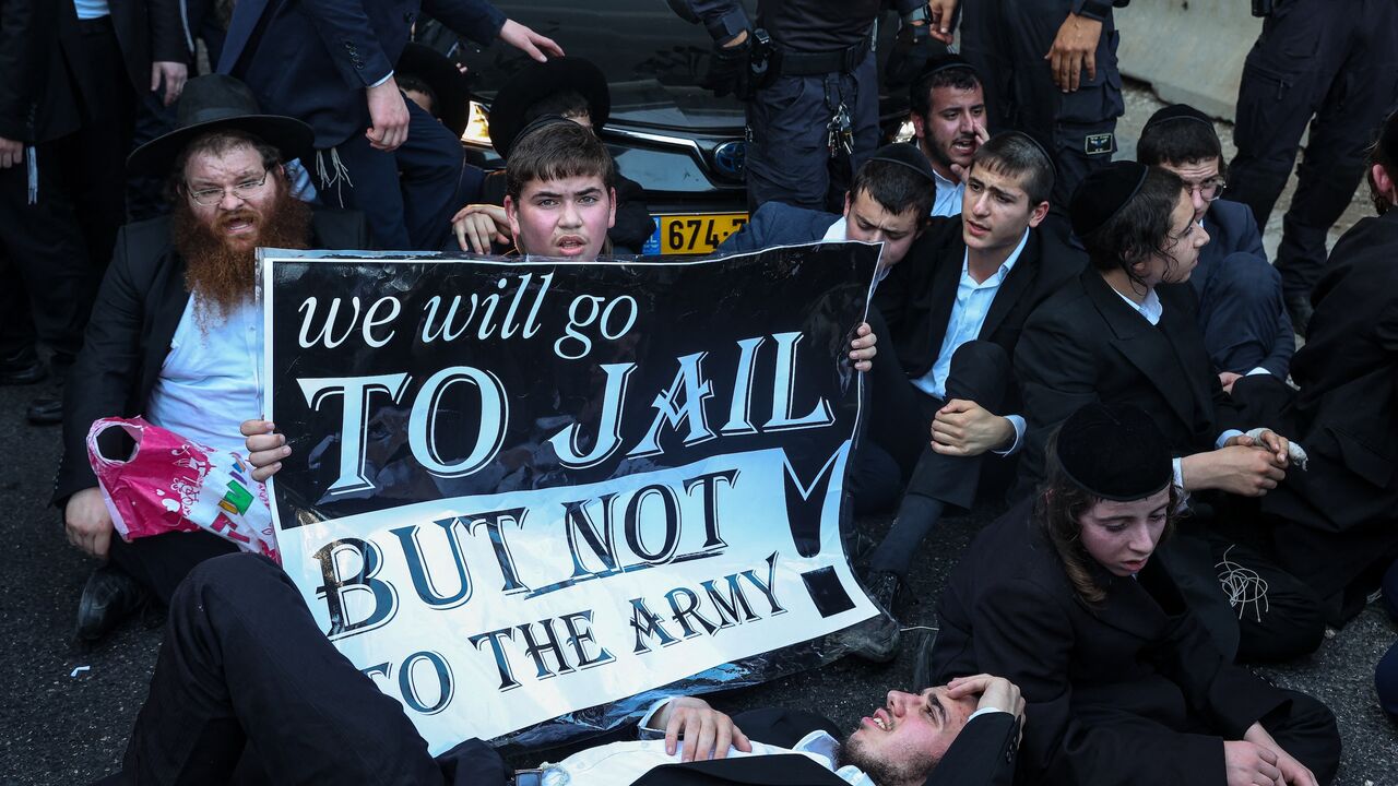 Israeli police officers clash with ultra-Orthodox Jewish men during a protest against their conscription, Bnei Brak, Israel, July 16, 2024.