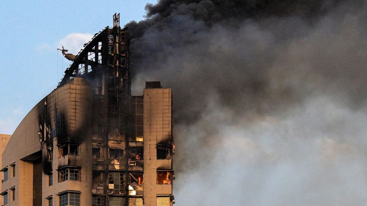 moke rises from a high-rise building following a drone attack in Kuwait City on March 8, 2026. 