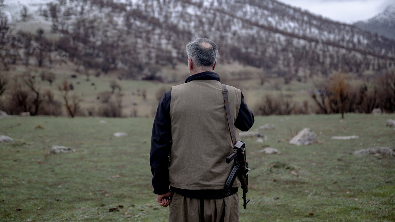 A Kurdish fighter from the Iranian Kurdish armed faction Kurdistan Free Life Party (PJAK) stands with his rifle at a site near the Iraqi border with Iran in Iraq's autonomous Kurdistan region, on March 8, 2026. 