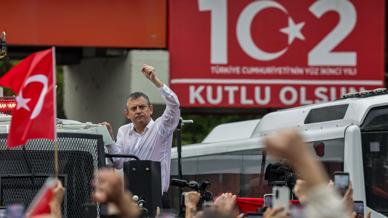 Turkey’s main opposition Republican People's Party's (CHP) Ousted party leader Ozgur Ozel waves to supporters from atop a police water cannon vehicle after being forcibly evicted by police from his party’s headquarters on May 24, 2026 in Ankara, Turkey.