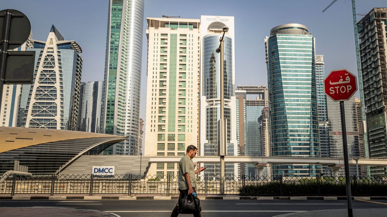A man crosses a street while returning home from work, in Dubai on June 23, 2026. (Photo by FADEL SENNA / AFP via Getty Images)