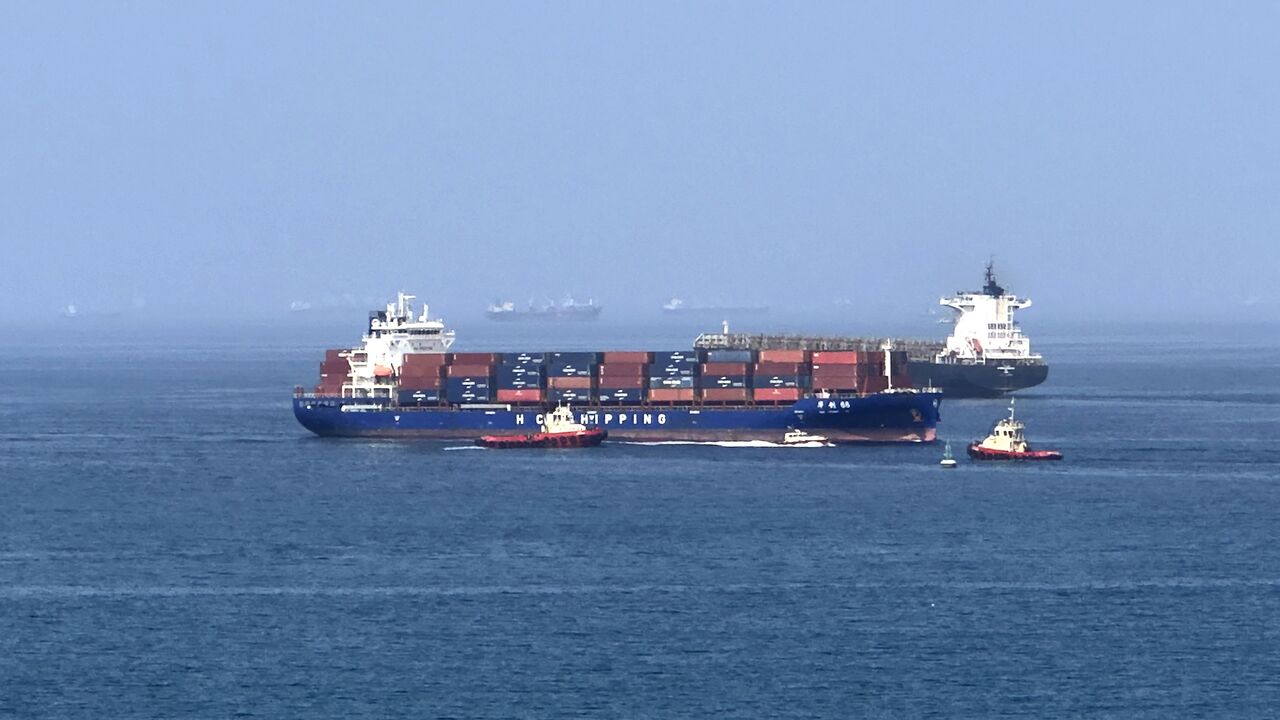 A cargo ship is pictured off coast of the Khor Fakkan Container Terminal, the only natural deep-sea port in the region and one of the major container ports in Sharjah Emirate, along the Gulf of Oman on June 28, 2026.