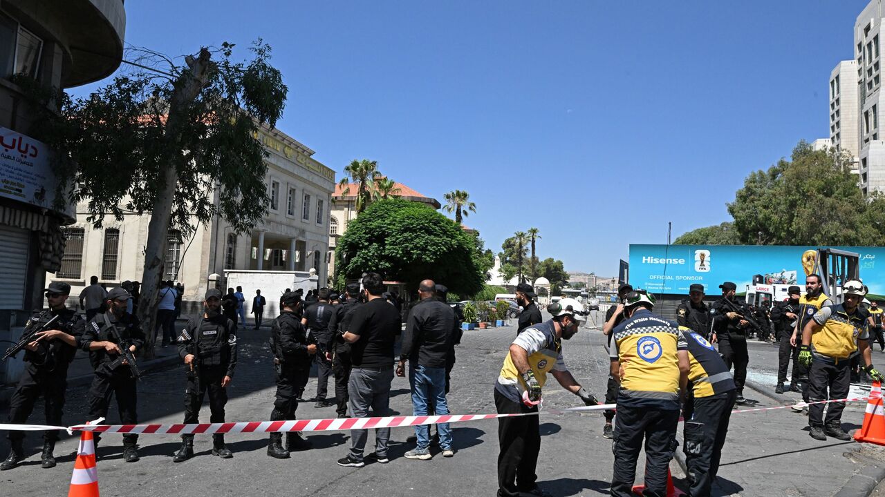 Security personnel and first responders prepare to cordon off an area near the Four Seasons Hotel following two blasts nearby in Damascus on July 7, 2026. Syrian authorities said 18 people were wounded by two blasts in central Damascus on July 7 near the hotel where France's president spent the night, with the Elysee Palace saying his visit is ongoing. (Photo by LOUAI BESHARA / AFP via Getty Images)