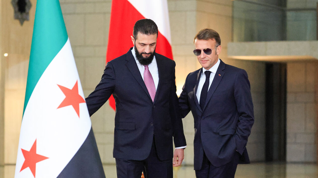 Syrian President Ahmed al-Sharaa (L) welcomes France's President Emmanuel Macron for a joint press conference in Damascus on July 7, 2026. 