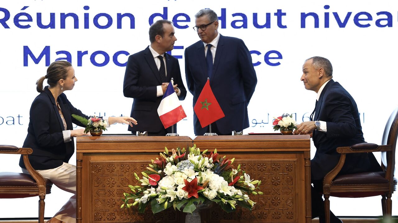 Director of European Affairs and Customs at La Poste Groupe Christelle Defaye-Geneste (L) and Morocco's Minister of Industry and Trade Ryad Mezzour (R) sign agreements between La Poste Groupe and Barid Al-Maghrib, alongside France's Prime Minister Sebastien Lecornu (C-L) and his Moroccan counterpart, Aziz Akhannouch, during a meeting in Rabat on July 16, 2026. 