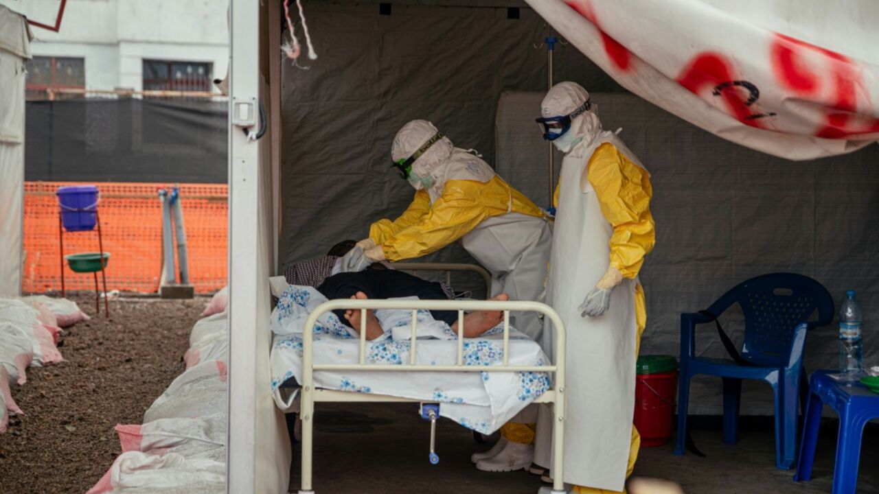 Doctors Without Borders (MSF) physicians move through the isolated red zone to monitor patients at an Ebola Treatment Center in Munigi, Congo