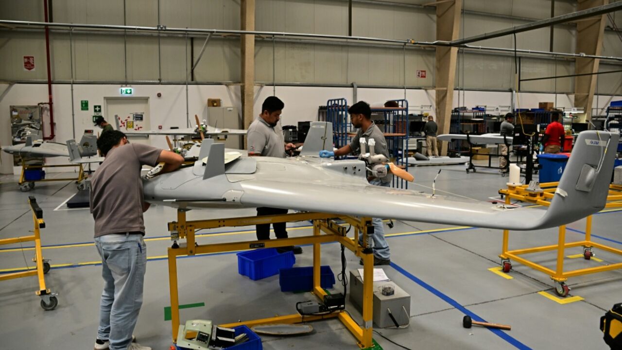 Employees work on the assembly unit of Shadow 50 drones inside the facility of 'EDGE Group', an Emirati advanced technology and defence conglomerate, in Abu Dhabi