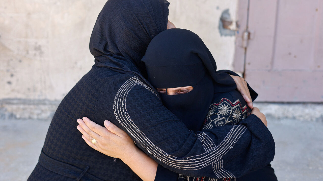 Mourners comfort each other, as they attend the funeral of Palestinian Saber Rabie, who was killed in an Israeli strike, according to medics, at Al-Aqsa Martyrs Hospital in Deir Al-Balah, in the central Gaza Strip, August 1, 2026. REUTERS/Mahmoud Issa