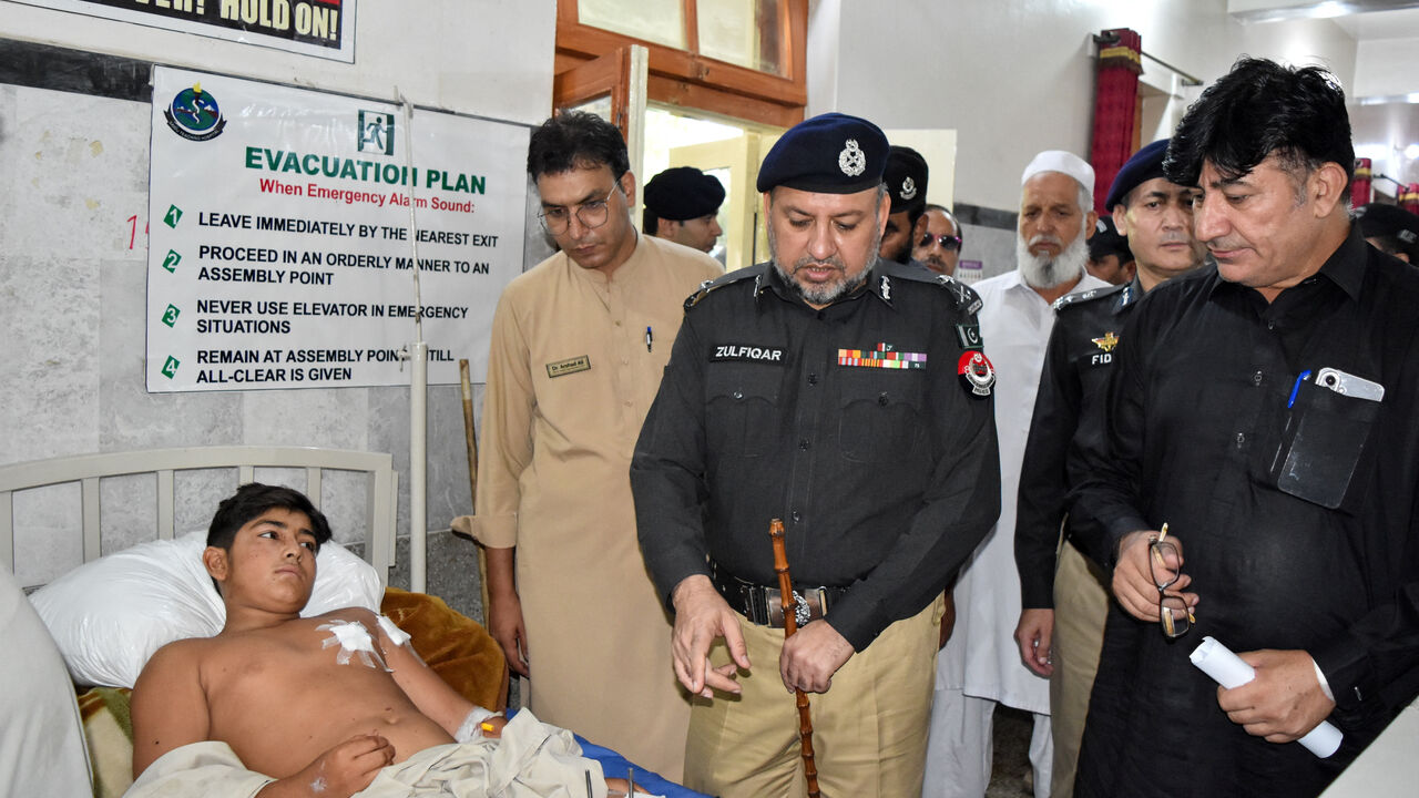 Inspector General of Police (IGP) Zulfiqar Hameed visits a boy who was among those injured in a suspected suicide bombing outside a police station, at a hospital in Swat district of Pakistan's Khyber Pakhtunkhwa province, Pakistan, August 3, 2026. REUTERS/Hazrat Ali Bacha