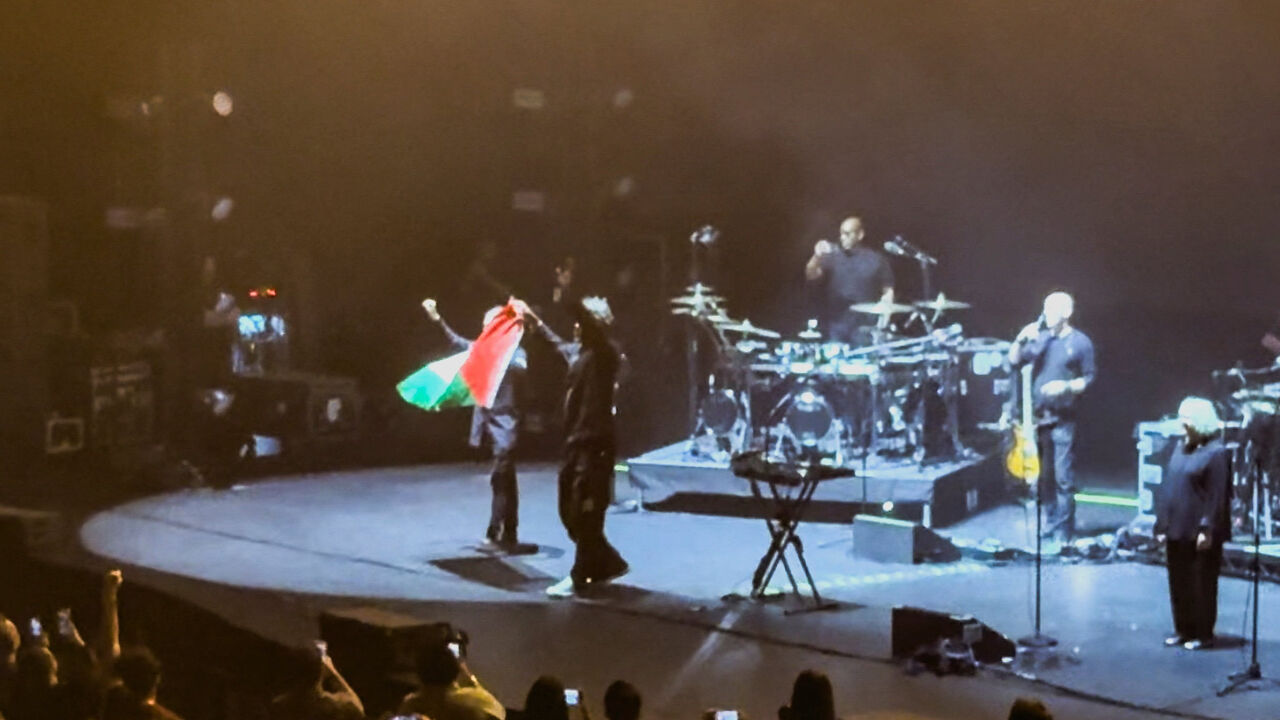 Robert Del Naja and Grant Marshall from Massive Attack stand with a Palestinian flag onstage at the end of their performance in Singapore, July 29, 2026, in this screengrab from video obtained from social media. Simran Panaech/via REUTERS