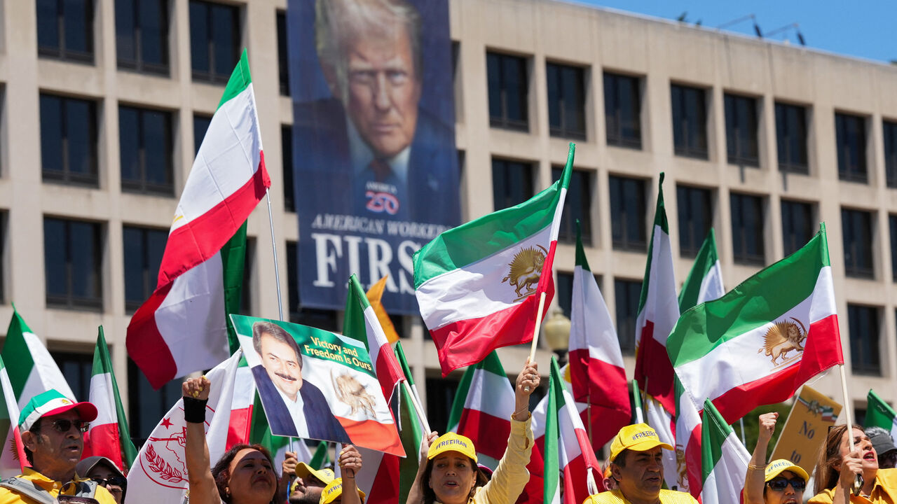 Iranian Americans and supporters of the National Council of Resistance of Iran take part in a march passing in front of the U.S Department of Labor building with a banner with the image of U.S. President Donald Trump, in Washington, D.C., U.S., May 16, 2026. REUTERS/Ken Cedeno