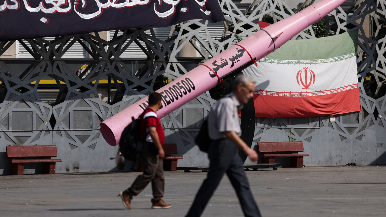 FILE PHOTO: People walk next to a symbolic mockup of an Iranian missile and an Iranian flag at Imam Hussein Square in Tehran, Iran, July 12, 2026. Majid Asgaripour/WANA (West Asia News Agency) via REUTERS/ File Photo