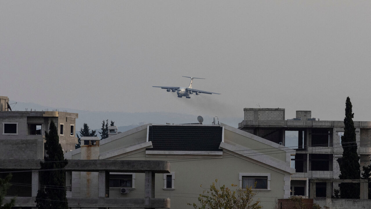 FILE PHOTO: A Russian military aircraft approaches the Hmeimim air base in Syria's coastal Latakia, Syria, December 15, 2024. REUTERS/Umit Bektas/File Photo