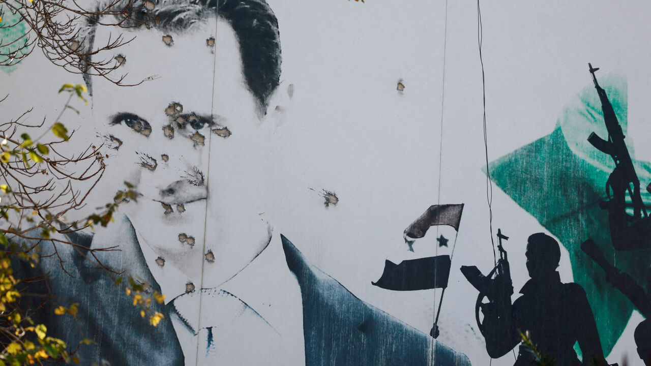 FILE PHOTO: A billboard with a picture of Syria's Bashar al-Assad shows damage by bullet holes, after the ousting of Syria's Bashar al-Assad, in Damascus, Syria, December 16, 2024. REUTERS/Ammar Awad/File Photo