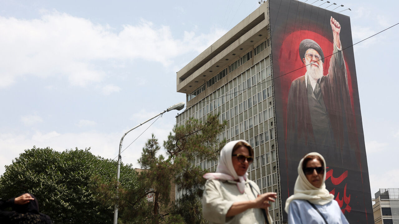 People walk near a billboard depicting Iran's late Supreme Leader Ayatollah Ali Khamenei, on a street in Tehran, Iran, August 3, 2026. Majid Asgaripour/WANA (West Asia News Agency) via REUTERS