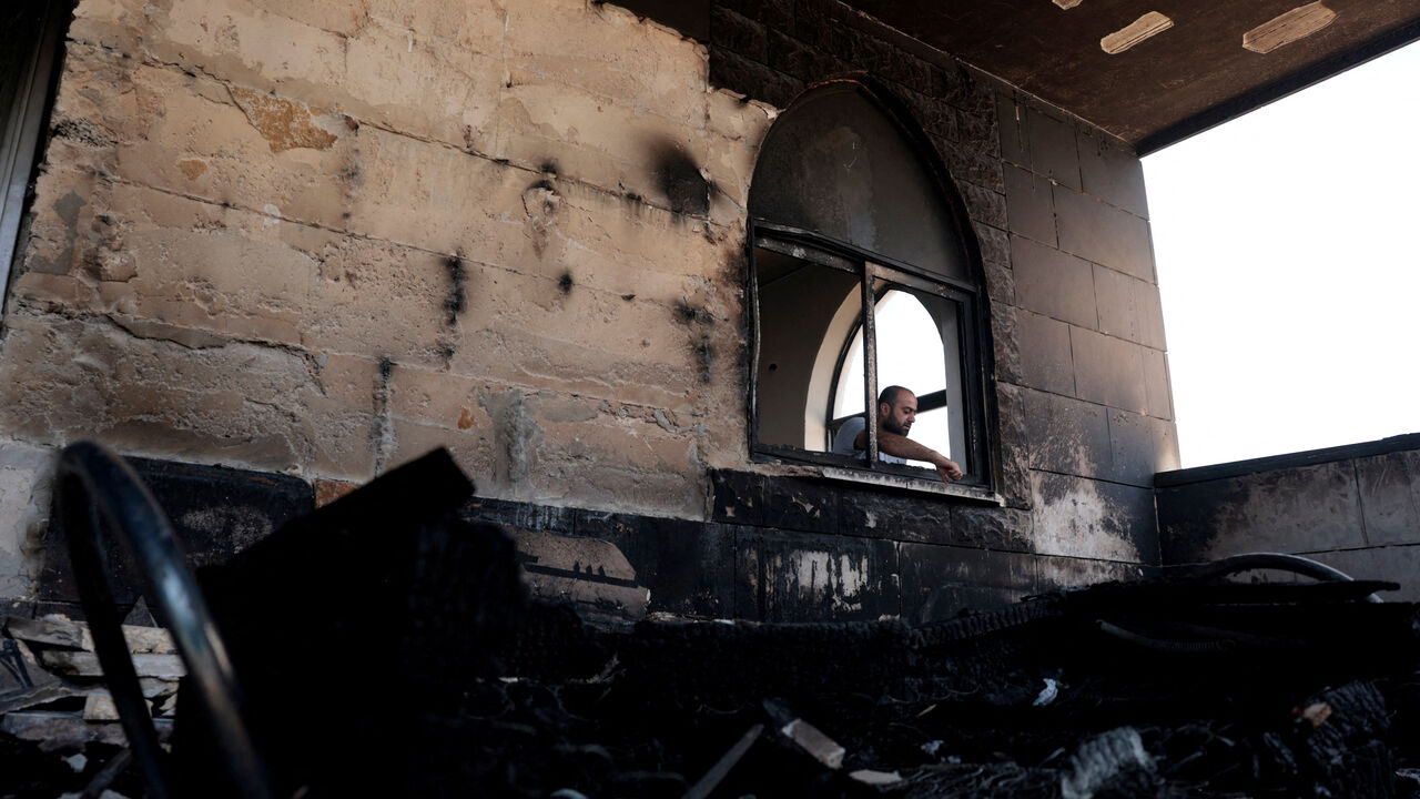 A Palestinian man inspects the damage at a mosque, which Palestinians say was damaged by Israeli settlers, in Qusra near Nablus, in the Israeli-occupied West Bank, July 26, 2026. REUTERS/Mohamad Torokman