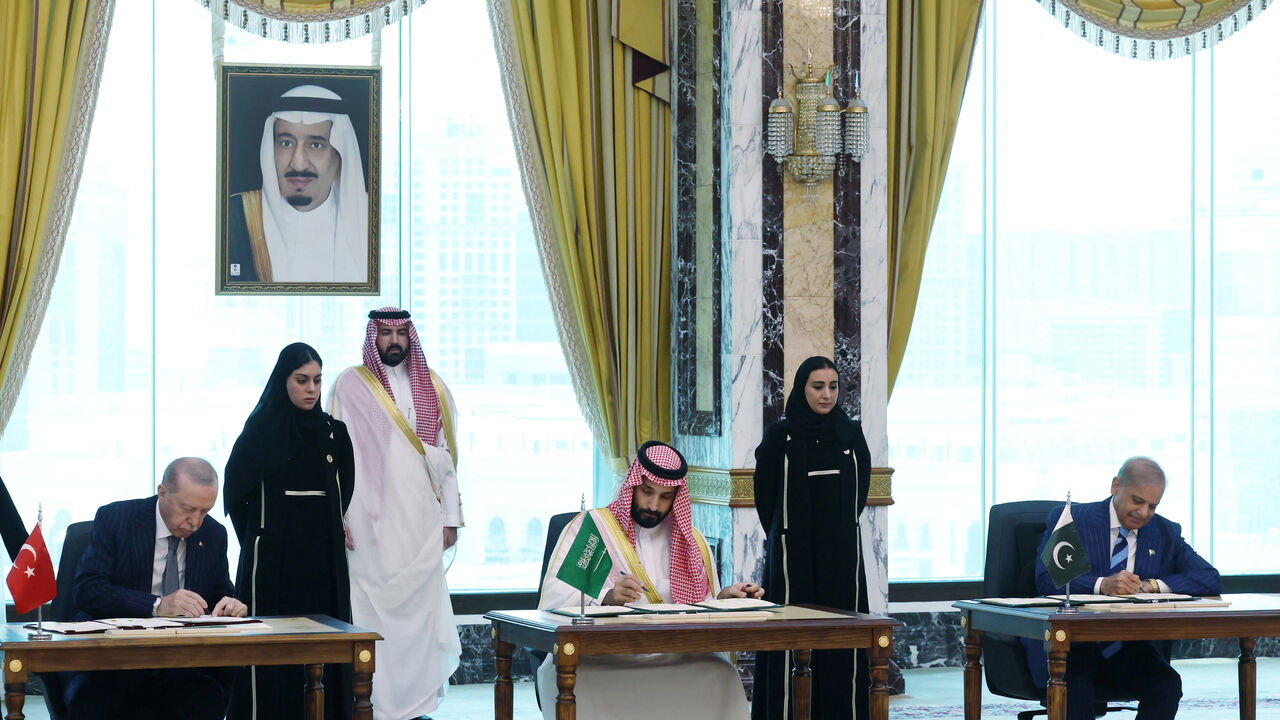 Turkish President Tayyip Erdogan, Saudi Crown Prince Mohammed bin Salman and Pakistan's Prime Minister Shehbaz Sharif sign a joint defense agreement in Mecca, Saudi Arabia, August 7, 2026. Murat Cetinmuhurdar/Turkish Presidential Press Office/Handout via REUTERS